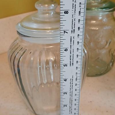 Three glass storage jars / canisters with lids