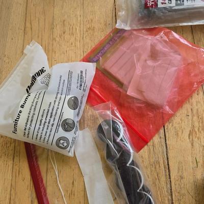 Assortment of homehardware - timers - zip ties - floor pads for furniture legs - and more