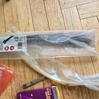 Assortment of homehardware - timers - zip ties - floor pads for furniture legs - and more