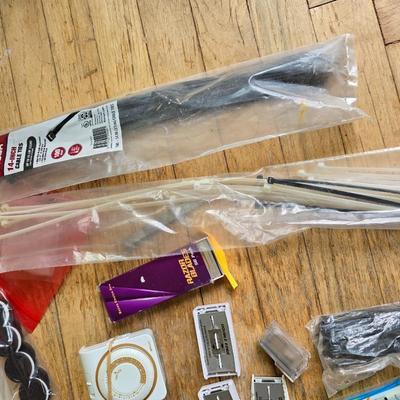 Assortment of homehardware - timers - zip ties - floor pads for furniture legs - and more