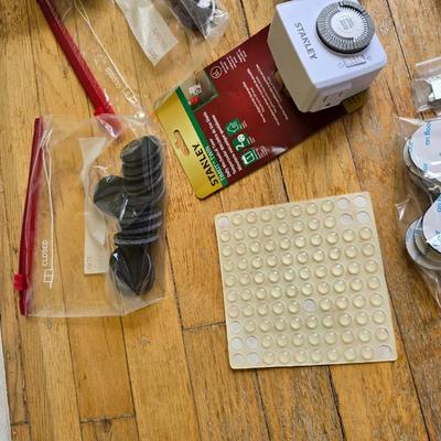 Assortment of homehardware - timers - zip ties - floor pads for furniture legs - and more