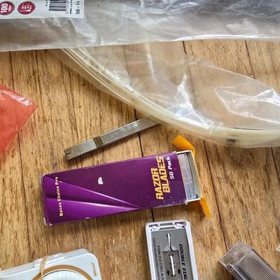 Assortment of homehardware - timers - zip ties - floor pads for furniture legs - and more