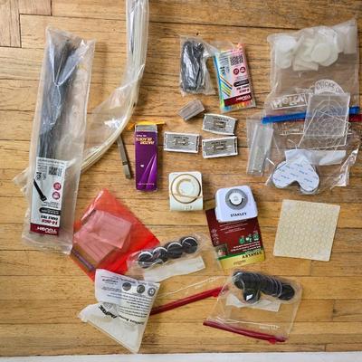Assortment of homehardware - timers - zip ties - floor pads for furniture legs - and more
