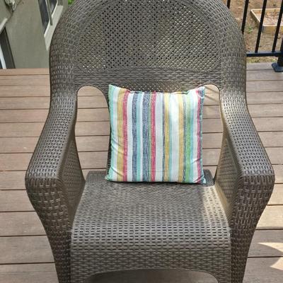 Faux wicker woven patio chair with outdoor throw pillow