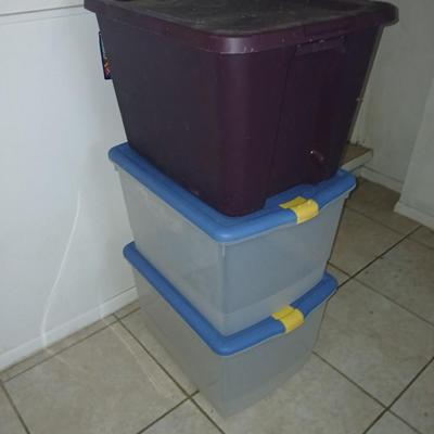 Three plastic storage totes with lids