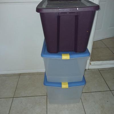 Three plastic storage totes with lids