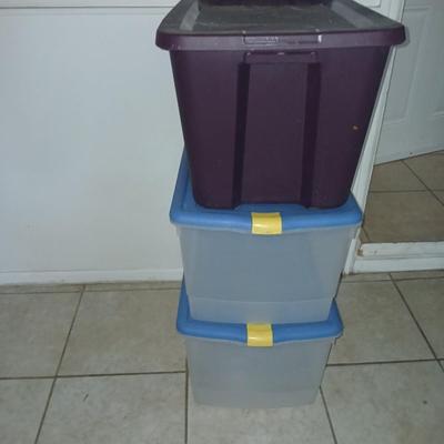 Three plastic storage totes with lids