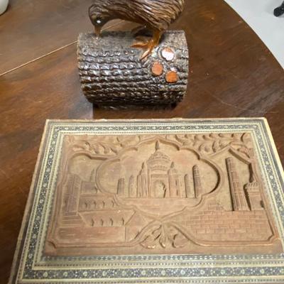 Wood carved bird and box filled with chess pieces