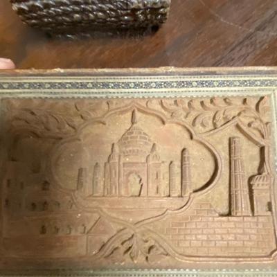Wood carved bird and box filled with chess pieces