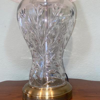 ANTIQUE PARLOR TABLE ON CASTERS AND A HEAVY CRYSTAL CUT LAMP