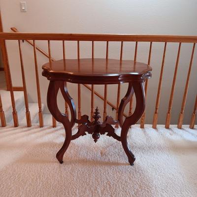 ANTIQUE PARLOR TABLE ON CASTERS AND A HEAVY CRYSTAL CUT LAMP
