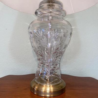 ANTIQUE PARLOR TABLE ON CASTERS AND A HEAVY CRYSTAL CUT LAMP
