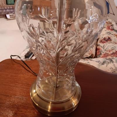 ANTIQUE PARLOR TABLE ON CASTERS AND A HEAVY CRYSTAL CUT LAMP