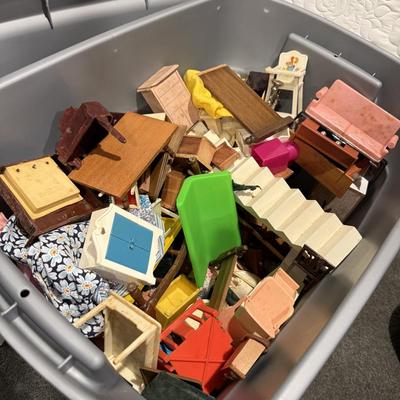 Vintage dollhouse and bin of accessories and furniture.