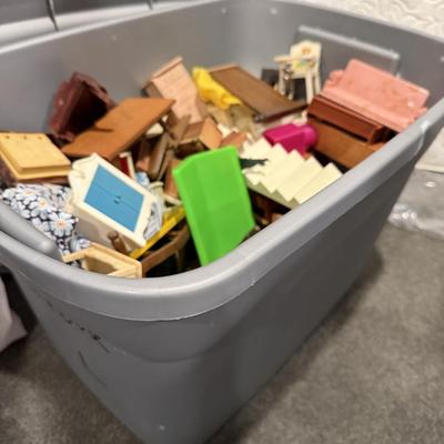 Vintage dollhouse and bin of accessories and furniture.