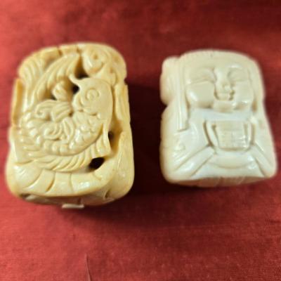 Sale Photo Thumbnail #22: This auction lot is for a Pair of Netsukis. This is a pair of carved bone or ivory-ite netsukis.  They are nicely ornate and are pierced top to bottom awaiting a satin cord to make a hanging or necklace.  They are approximately 2-inches tall.