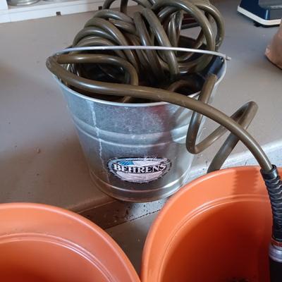 FLOWER POTS, GARDEN HOSE W/SPRAYER, PARTIAL BAG OF SOIL AND MORE