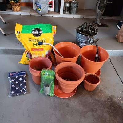 FLOWER POTS, GARDEN HOSE W/SPRAYER, PARTIAL BAG OF SOIL AND MORE