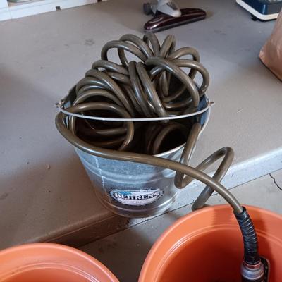 FLOWER POTS, GARDEN HOSE W/SPRAYER, PARTIAL BAG OF SOIL AND MORE