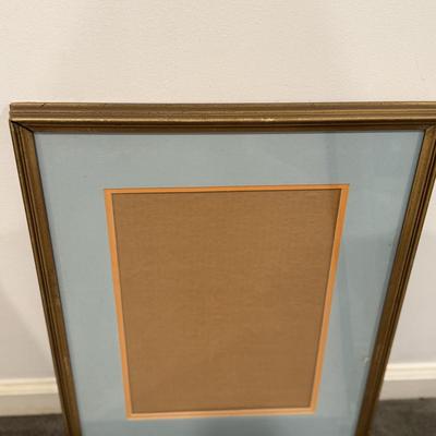 Two famed posters and one empty frame