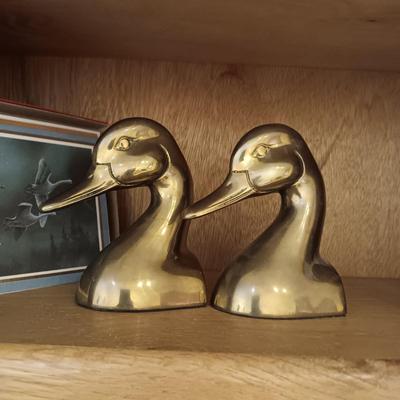A PAIR OF BRASS DUCK HEAD BOOKENDS AN A PEWTER ELK