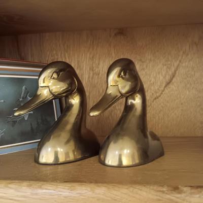 A PAIR OF BRASS DUCK HEAD BOOKENDS AN A PEWTER ELK