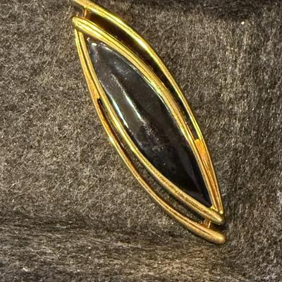 Black and gold pin