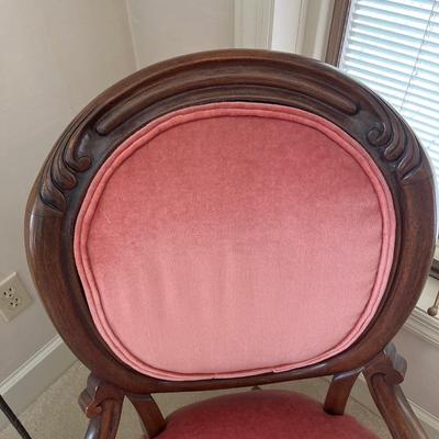 Pink side chair and fireplace tools