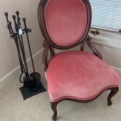 Pink side chair and fireplace tools