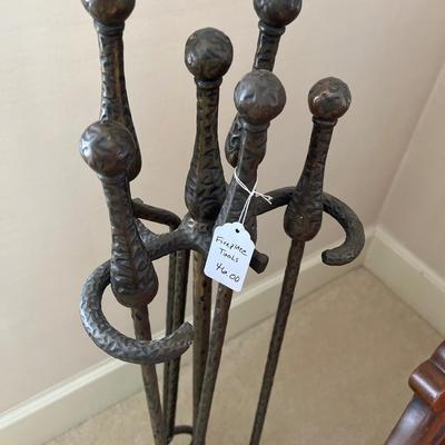 Pink side chair and fireplace tools