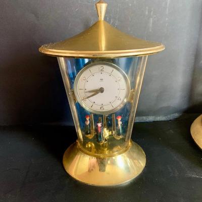 LOT 309: German Kern Anniversary Clock with Enamel Face and Base with Porcelain Figures and Vintage 8 Day Clock with German Figures on...