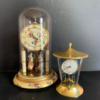 LOT 309: German Kern Anniversary Clock with Enamel Face and Base with Porcelain Figures and Vintage 8 Day Clock with German Figures on...