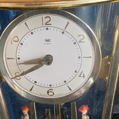 LOT 309: German Kern Anniversary Clock with Enamel Face and Base with Porcelain Figures and Vintage 8 Day Clock with German Figures on...