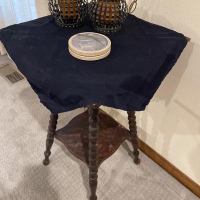Small vintage table with coasters and candles