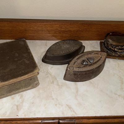 Vintage irons, coasters and books