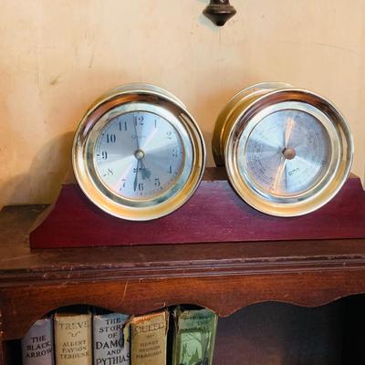 LOT 667: Bookcase with Classic Books, Mantle Weather Station, Side Table with Shelf and Anniversary Clock