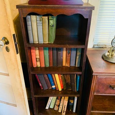 LOT 667: Bookcase with Classic Books, Mantle Weather Station, Side Table with Shelf and Anniversary Clock