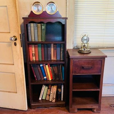 LOT 667: Bookcase with Classic Books, Mantle Weather Station, Side Table with Shelf and Anniversary Clock