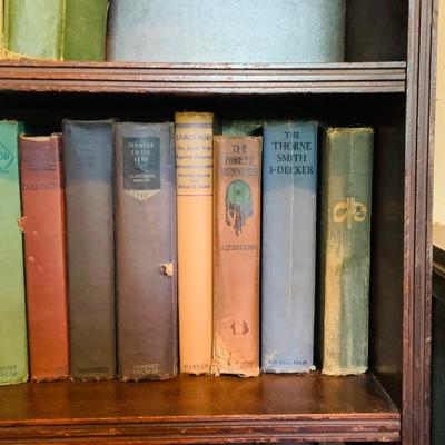 LOT 667: Bookcase with Classic Books, Mantle Weather Station, Side Table with Shelf and Anniversary Clock