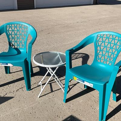 Metal table and two plastic blue chairs, looks new