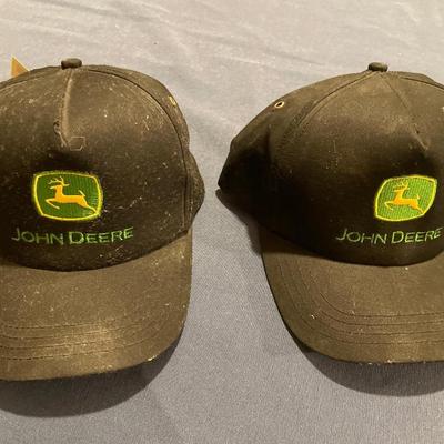 2 black John Deere hats with tags