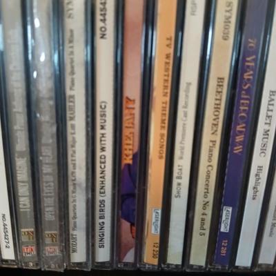 Tall Narrow Black Media Shelf – CD/DVD Storage Tower with an assortment of cd's