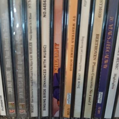 Tall Narrow Black Media Shelf – CD/DVD Storage Tower with an assortment of cd's