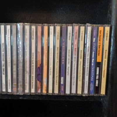 Tall Narrow Black Media Shelf – CD/DVD Storage Tower with an assortment of cd's