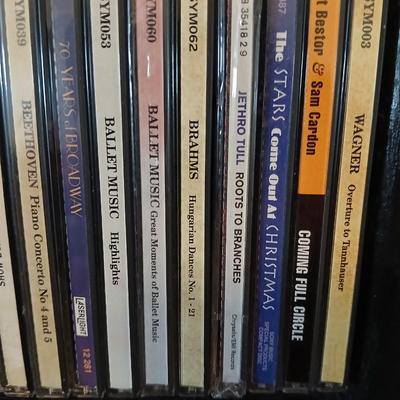 Tall Narrow Black Media Shelf – CD/DVD Storage Tower with an assortment of cd's