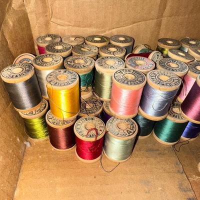 MANY WOODEN SPOOLS OF THREAD