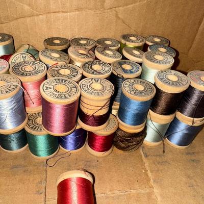 MANY WOODEN SPOOLS OF THREAD
