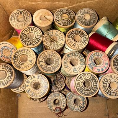 MANY WOODEN SPOOLS OF THREAD