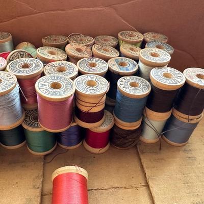 MANY WOODEN SPOOLS OF THREAD