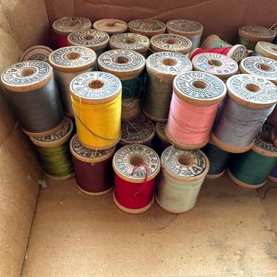 MANY WOODEN SPOOLS OF THREAD